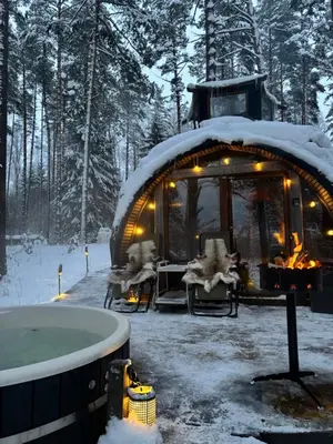 a igloo with a hot tub in the snow at Lakajų Resort in Molėtai