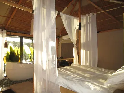a bedroom with a canopy bed and a bath tub at Lakajų Resort in Molėtai