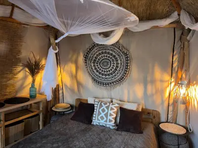 a bedroom with a bed with a canopy at Lakajų Resort in Molėtai