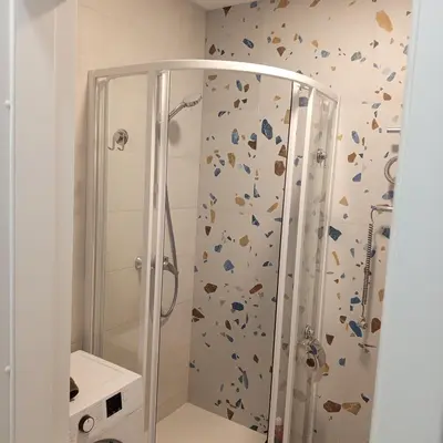 a bathroom with a shower with a shower curtain at VilniusCentralSpot in Vilnius