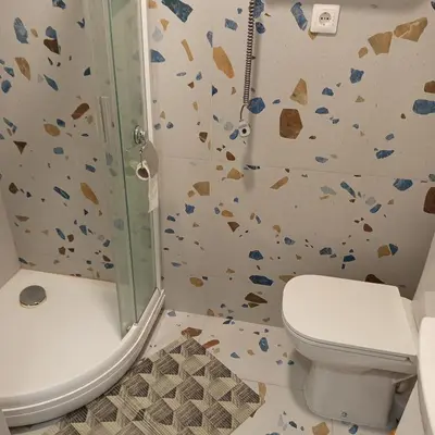 a bathroom with a shower and a toilet in it at VilniusCentralSpot in Vilnius