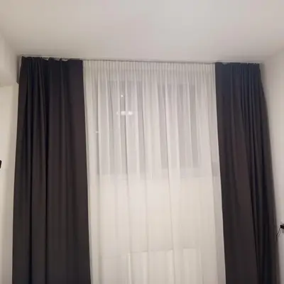 a window with black and white curtains in a room at VilniusCentralSpot in Vilnius