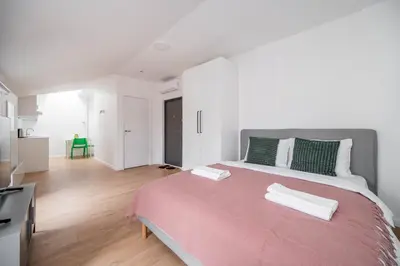 a bedroom with a large bed with two towels on it at LUMA Apartments by Reside Baltic in Vilnius