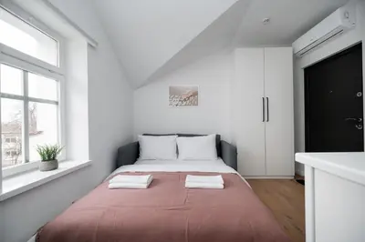 a bedroom with a bed with two towels on it at LUMA Apartments by Reside Baltic in Vilnius