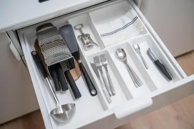 a drawer filled with utensils in a cabinet at LUMA Apartments by Reside Baltic in Vilnius