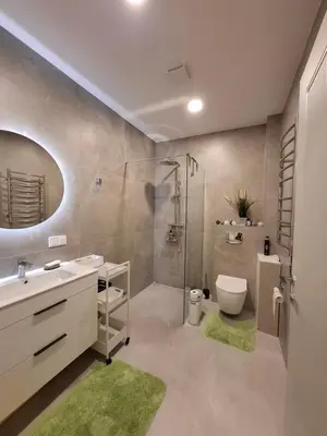 a bathroom with a shower and a toilet and a sink at Ievos apartamentai in Birštonas