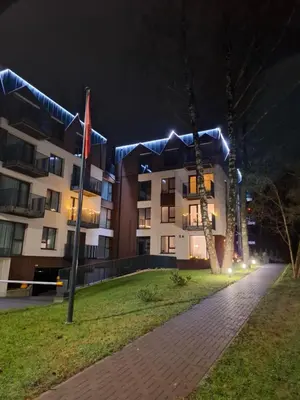 a building with blue lights on it at night at Ievos apartamentai in Birštonas