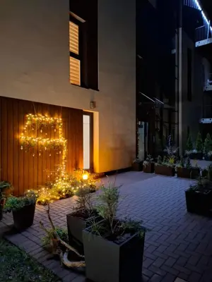 a courtyard with christmas lights in a building at night at Ievos apartamentai in Birštonas