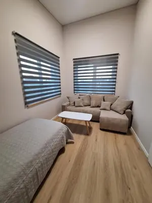 a living room with a couch and a table at Kambarių nuoma prie Kauno oro uosto in Karmėlava