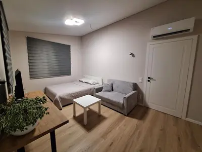 a room with a bed and a chair and a table at Kambarių nuoma prie Kauno oro uosto in Karmėlava