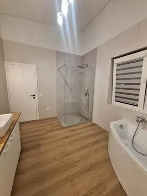 a bathroom with a shower and a tub and a sink at Kambarių nuoma prie Kauno oro uosto in Karmėlava