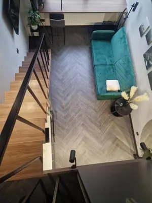 an overhead view of a living room with a green couch at Stylish loft in Vilnius