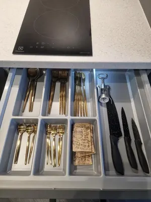 a drawer filled with utensils in a counter at Stylish loft in Vilnius