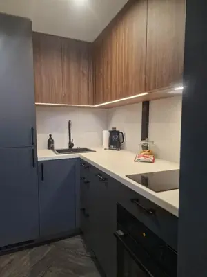 a kitchen with wooden cabinets and a sink at Stylish loft in Vilnius