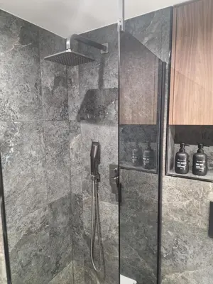a bathroom with a shower with a glass door at Stylish loft in Vilnius