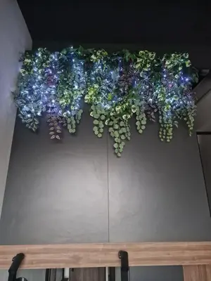 a bunch of blue and green plants on a wall at Stylish loft in Vilnius