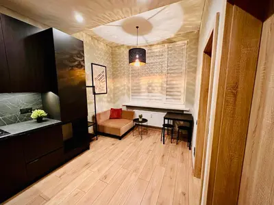a living room with a couch and a table at M&M Apartment IV SELF CHECK-IN in Panevėžys
