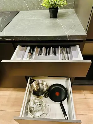 a kitchen drawer with a pot and pans in it at M&M Apartment IV SELF CHECK-IN in Panevėžys