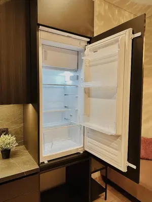 an empty refrigerator with its door open in a kitchen at M&M Apartment IV SELF CHECK-IN in Panevėžys
