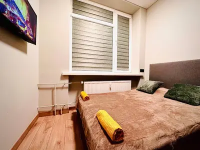 a bedroom with a large bed with a large window at M&M Apartment IV SELF CHECK-IN in Panevėžys