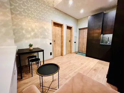 a living room with a table and chairs in a room at M&M Apartment IV SELF CHECK-IN in Panevėžys