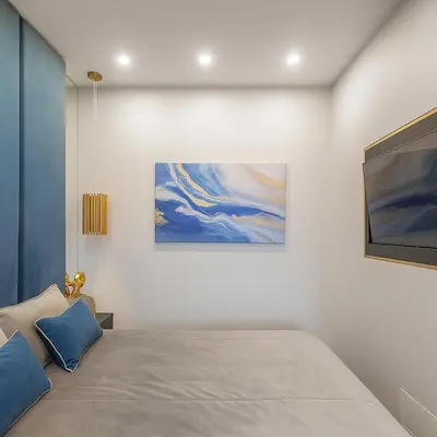 a bedroom with a bed and a painting on the wall at Self Check-in Apartment in Vilnius