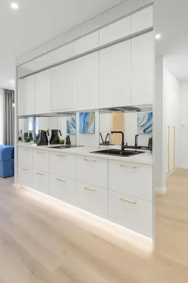 a large white kitchen with white cabinets at Self Check-in Apartment in Vilnius