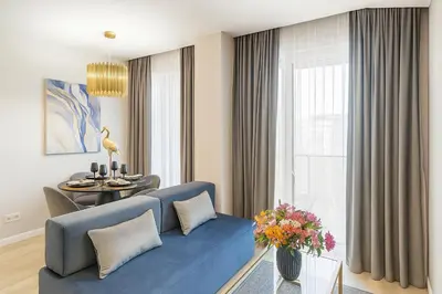 a living room with a blue couch and a table at Self Check-in Apartment in Vilnius