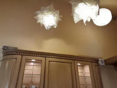 two lights hanging from the ceiling above a kitchen cabinets at Studio apart in Vilnius