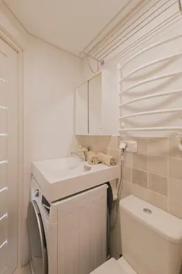 a white bathroom with a sink and a toilet at Vilnius prie centro ramybė tarp medžių in Vilnius