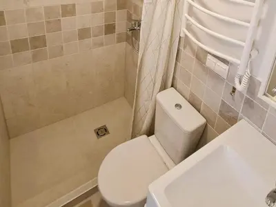 a bathroom with a toilet and a shower and a sink at Vilnius prie centro ramybė tarp medžių in Vilnius