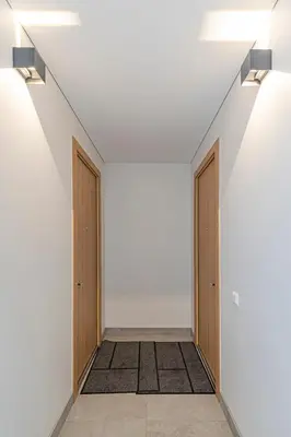 an empty hallway with two doors and a rug at Vytauto 43 Residence – Lietūkis by Domvia in Kaunas