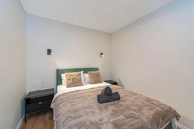 a bedroom with a large bed in a room at Vytauto 43 Residence – Lietūkis by Domvia in Kaunas