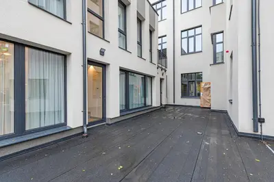 an empty courtyard of a building with windows at Vytauto 43 Residence – Lietūkis by Domvia in Kaunas