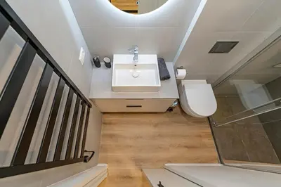 a bathroom with a sink and a toilet at Vytauto 43 Residence – Lietūkis by Domvia in Kaunas