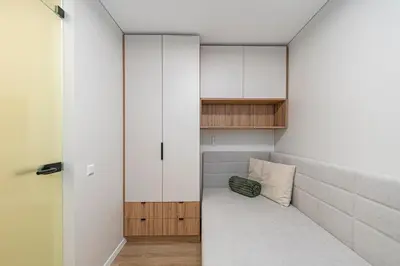 a small room with a couch and white cabinets at Vytauto 43 Residence – Lietūkis by Domvia in Kaunas
