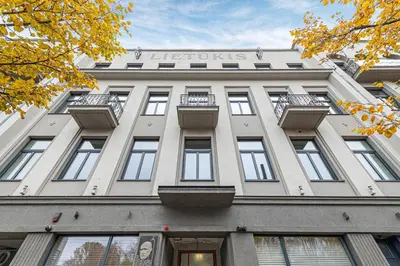 a large white building with a sign on it at Vytauto 43 Residence – Lietūkis by Domvia in Kaunas