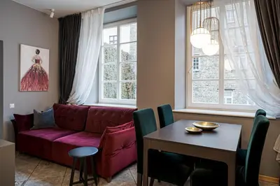 a living room with a red couch and a table at Bernardinu Boutique in Vilnius