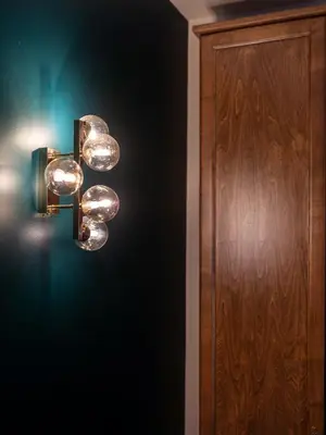 a light fixture on a wall next to a door at Bernardinu Boutique in Vilnius