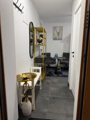a hallway with a table and a mirror at Flat In the heart of Kaunas city center in Kaunas
