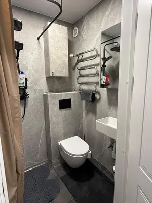 a small bathroom with a toilet and a sink at Flat In the heart of Kaunas city center in Kaunas