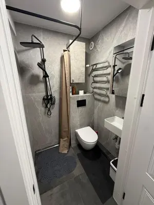 a bathroom with a toilet and a shower and a sink at Flat In the heart of Kaunas city center in Kaunas