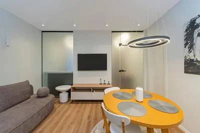 a living room with a table and a couch at Vytauto 43 Residence 3 by Domvia in Kaunas