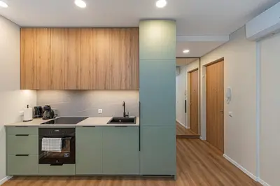 an empty kitchen with a sink and a stove at Vytauto 43 Residence 3 by Domvia in Kaunas