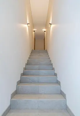 a stairway in a building with grey stairs at Vytauto 43 Residence 3 by Domvia in Kaunas