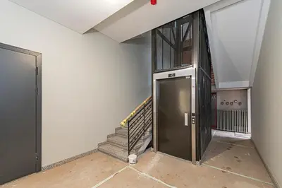 a hallway with a door and stairs in a building at Vytauto 43 Residence 3 by Domvia in Kaunas