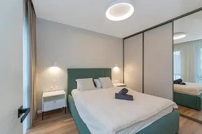 a bedroom with a large bed and a mirror at Vytauto 43 Residence 3 by Domvia in Kaunas