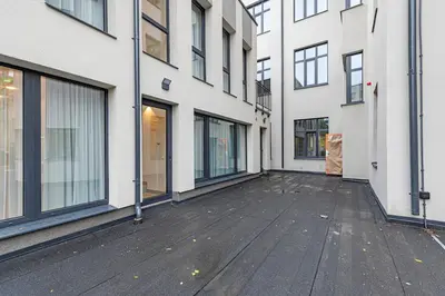 an empty courtyard of a building with windows at Vytauto 43 Residence 4 by Domvia in Kaunas