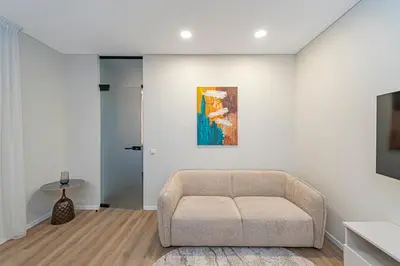 a living room with a couch and a painting on the wall at Vytauto 43 Residence 4 by Domvia in Kaunas