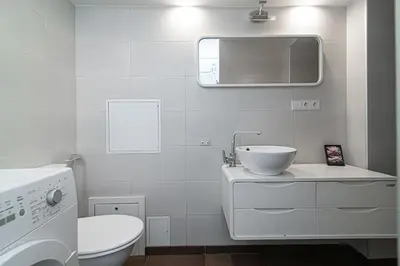 a white bathroom with a sink and a toilet at 1 bedroom apartment in old town with free parking in Vilnius